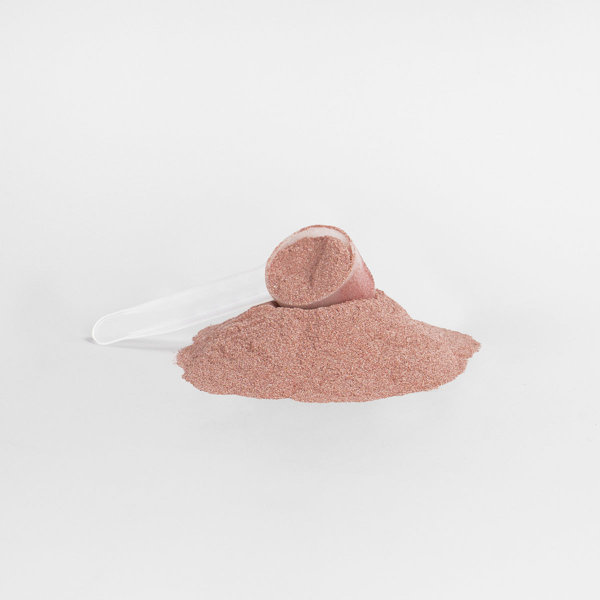 plastic scoop on a pile of red powder