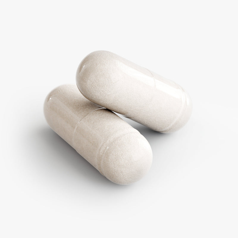 Two beige capsules on a white background