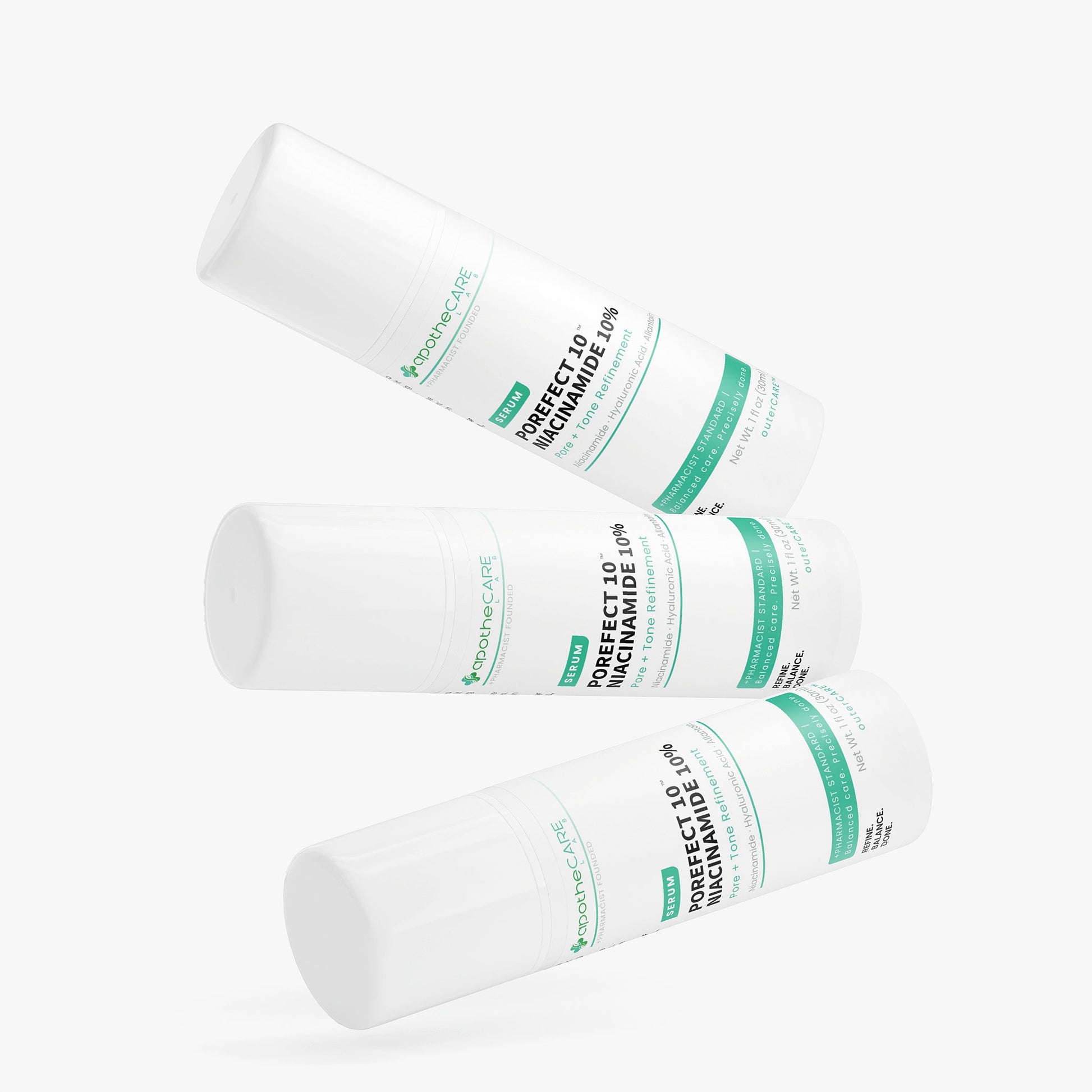Three white cylindrical containers with green labels on a white background
