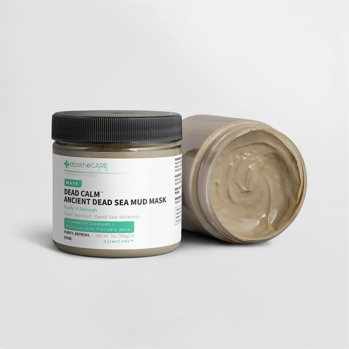 Dead Sea mud mask jar with open lid on a white background