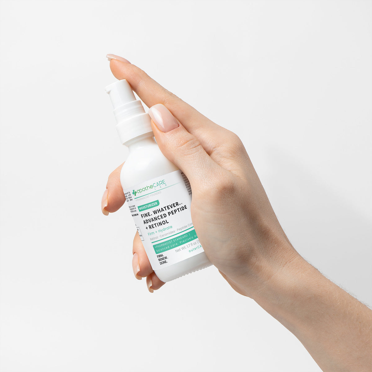 Hand holding a skincare product bottle with a white background