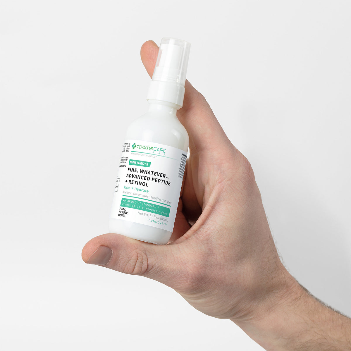 Hand holding a bottle labeled 'Fine. Whatever.' against a white background
