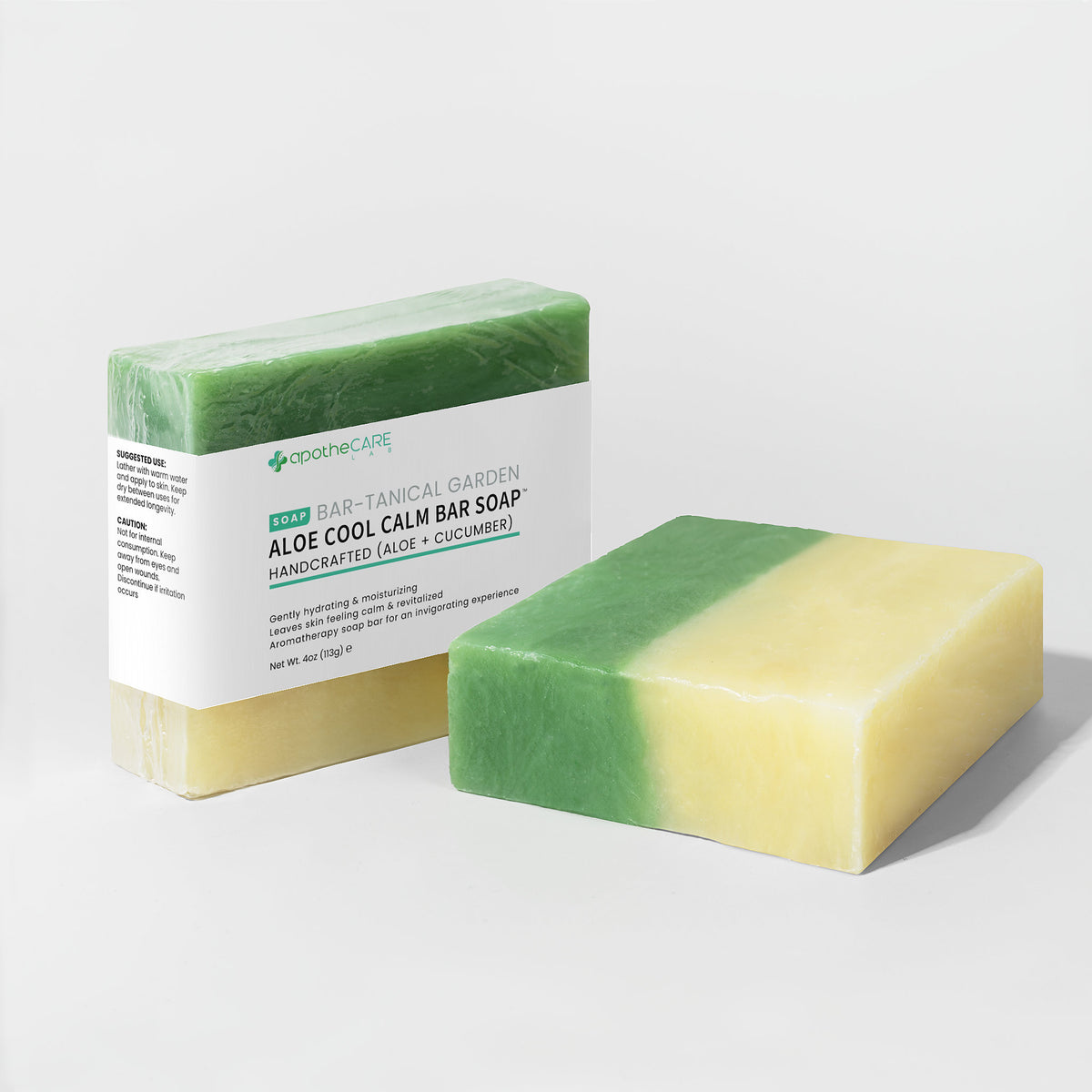 Two bars of aloe cool calm bar soap with a label on a light gray background