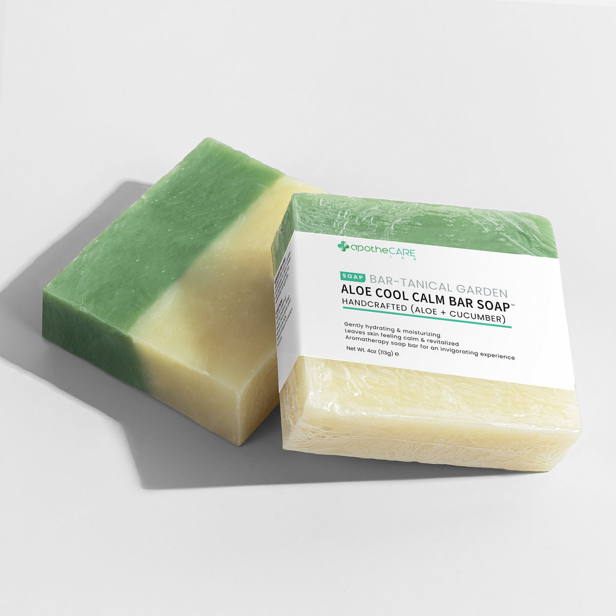 Two bars of soap, half green and half beige, with a label on a light gray background.