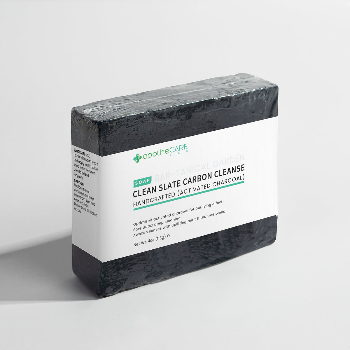 Bar of charcoal soap on a light gray background