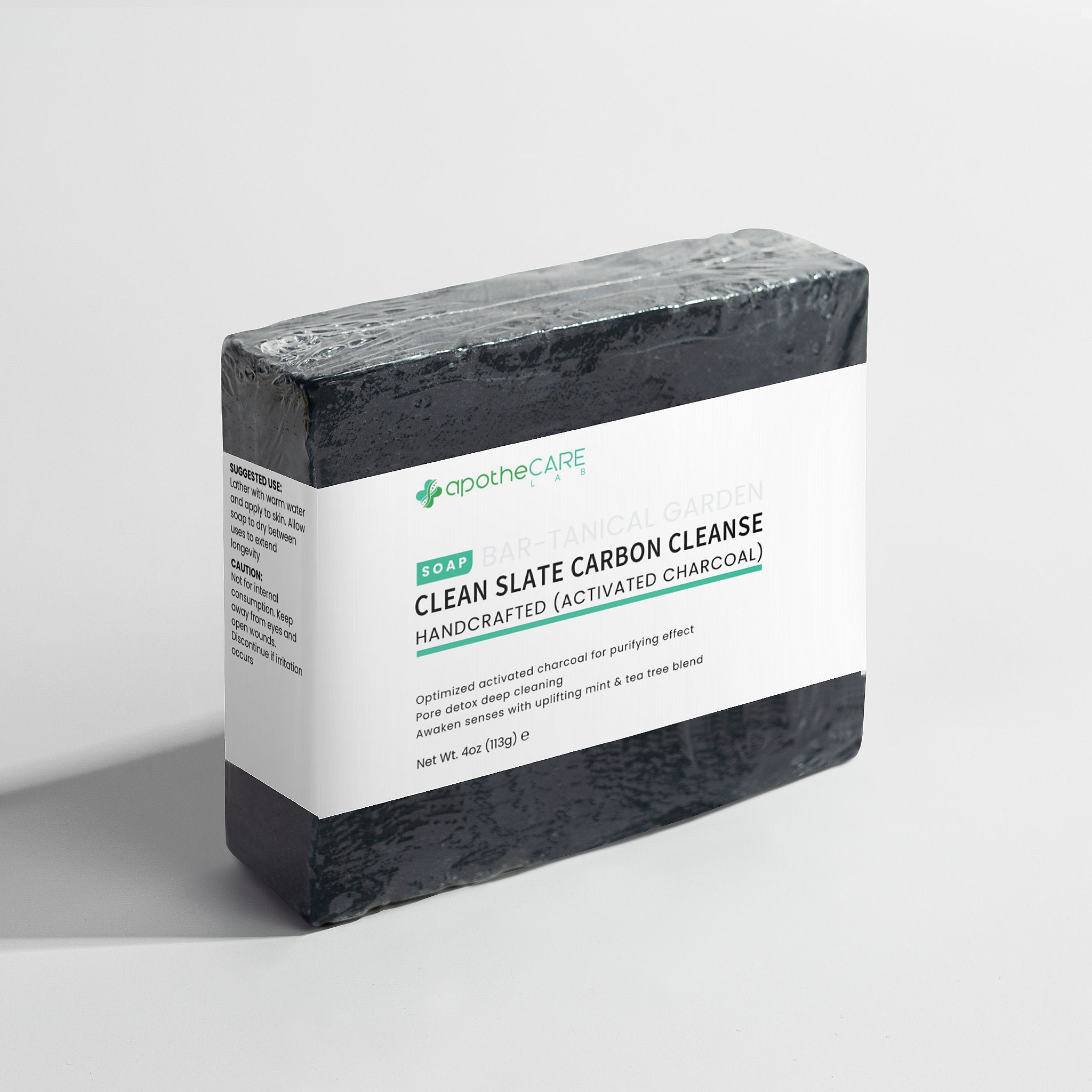 Bar of charcoal soap on a light gray background