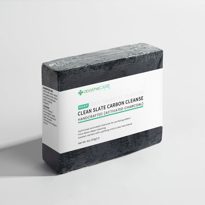 Bar of charcoal soap on a light gray background