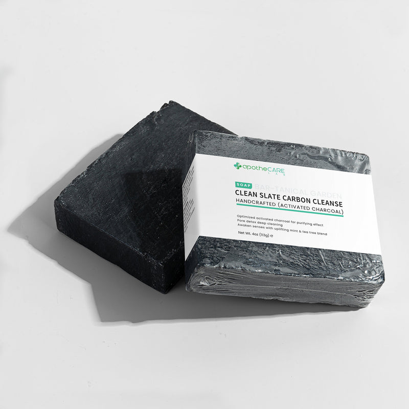 Two bars of charcoal soap with a label on a white background