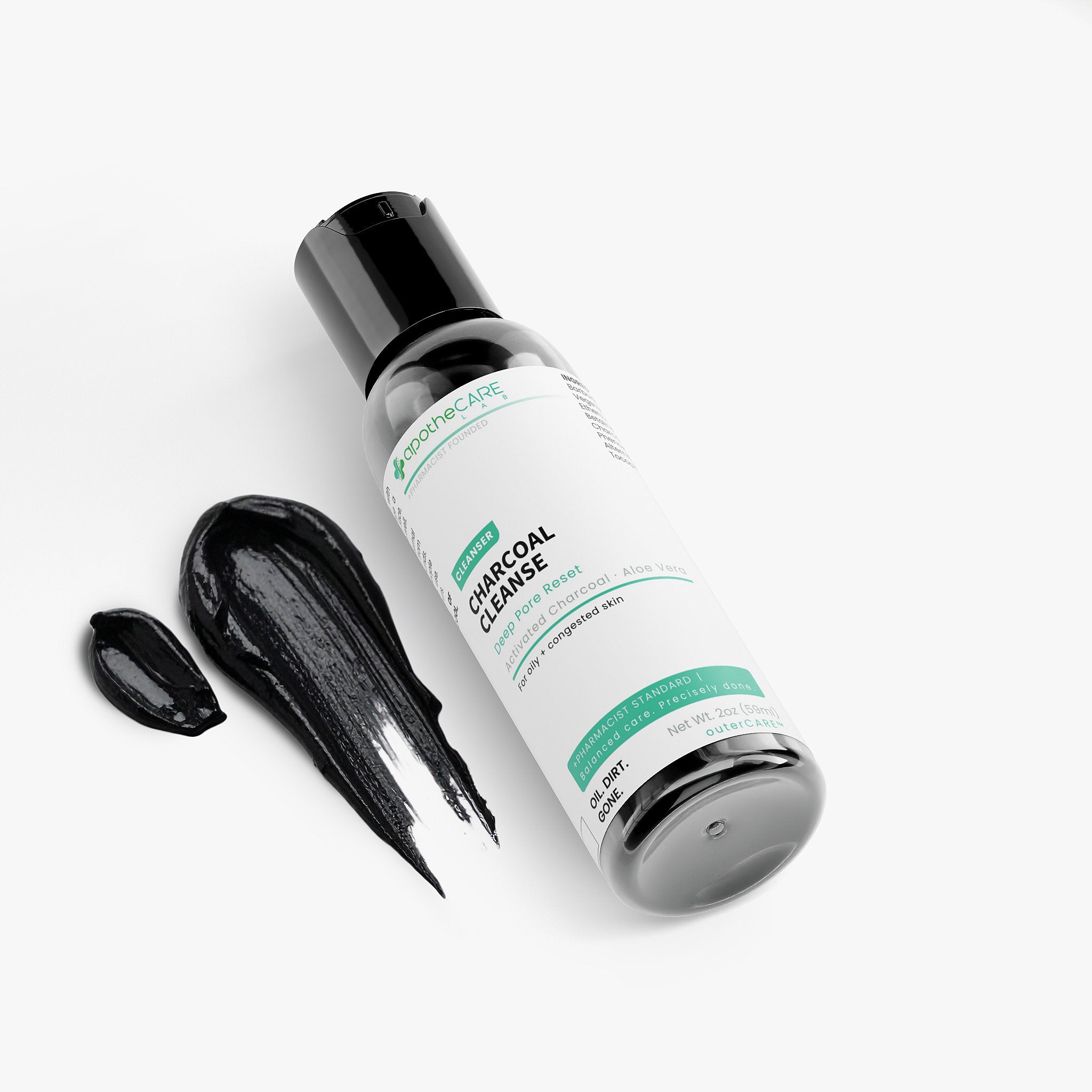 A bottle of Charcoal Cleanse, shown on a clean white background with a smear of the black cleanser and a small droplet next to it.