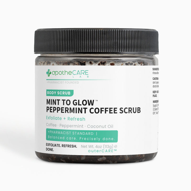 A jar of apotheCARE Lab Mint to Glow Peppermint Coffee Scrub with a black ribbed lid and a white label, set against a plain white background.