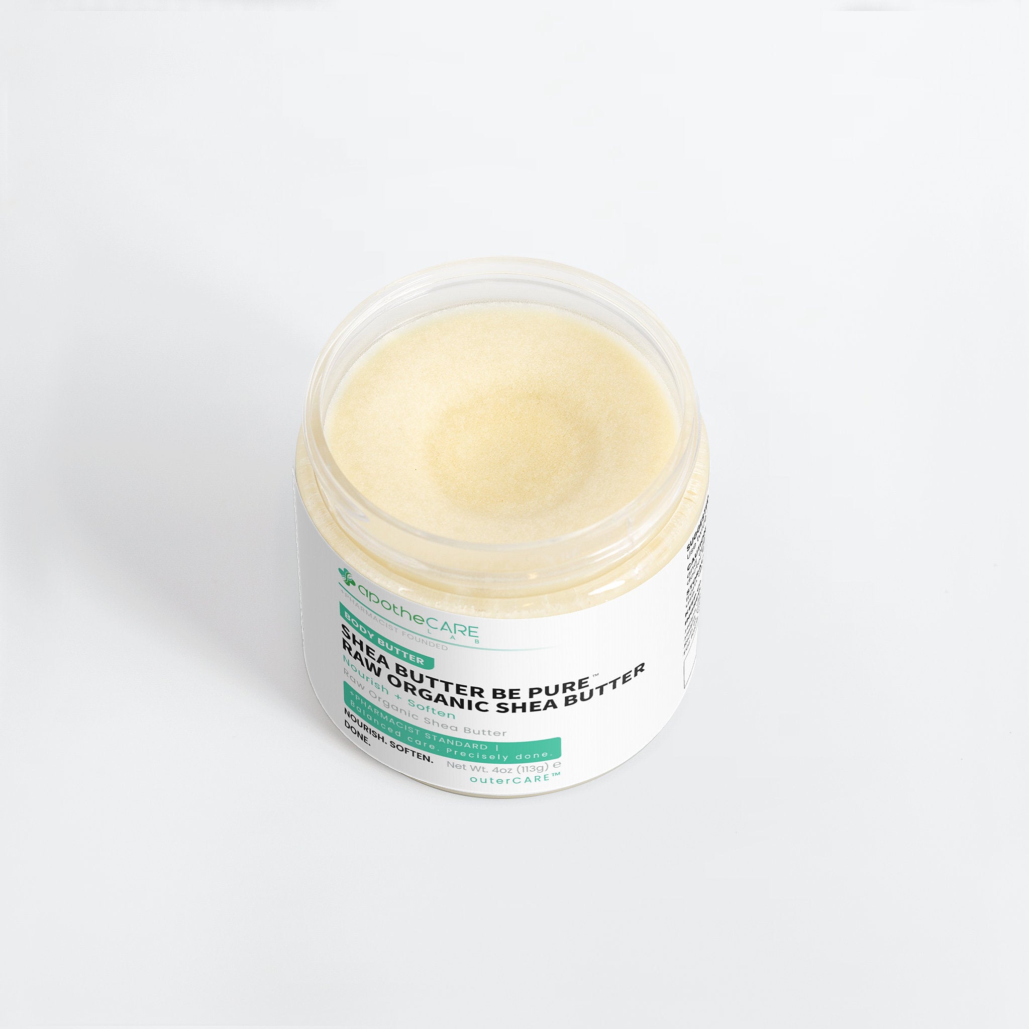 A jar of Organic Care Shea Butter Be Pure organic shea butter, showing the pale yellow cream inside a clear plastic jar with a white label on a light gray background.