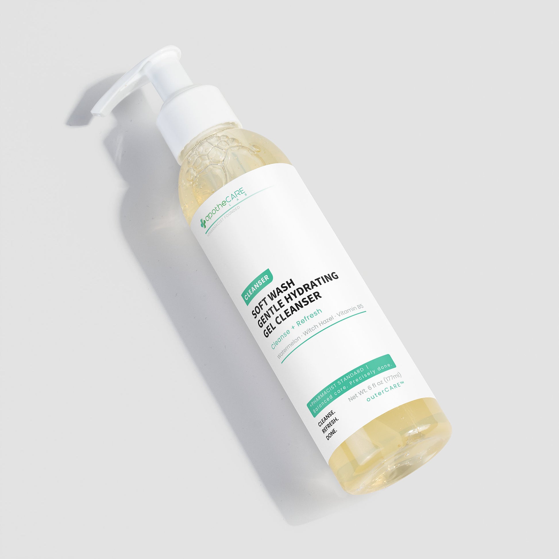 A bottle of Soft Wash Softly Hydrating Gel Cleanser, filled with a pale yellow gel, shown on a light gray background with a soft shadow.