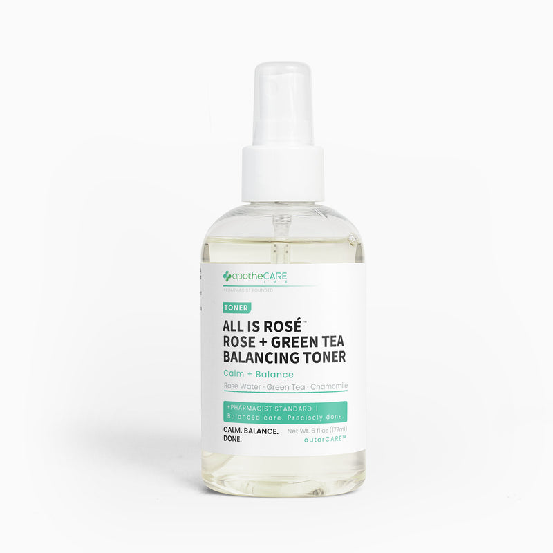 A clear plastic bottle of apotheCARE LAB All Is Rosé Rose + Green Tea Balancing Toner with a white spray pump, shown on a clean white background.