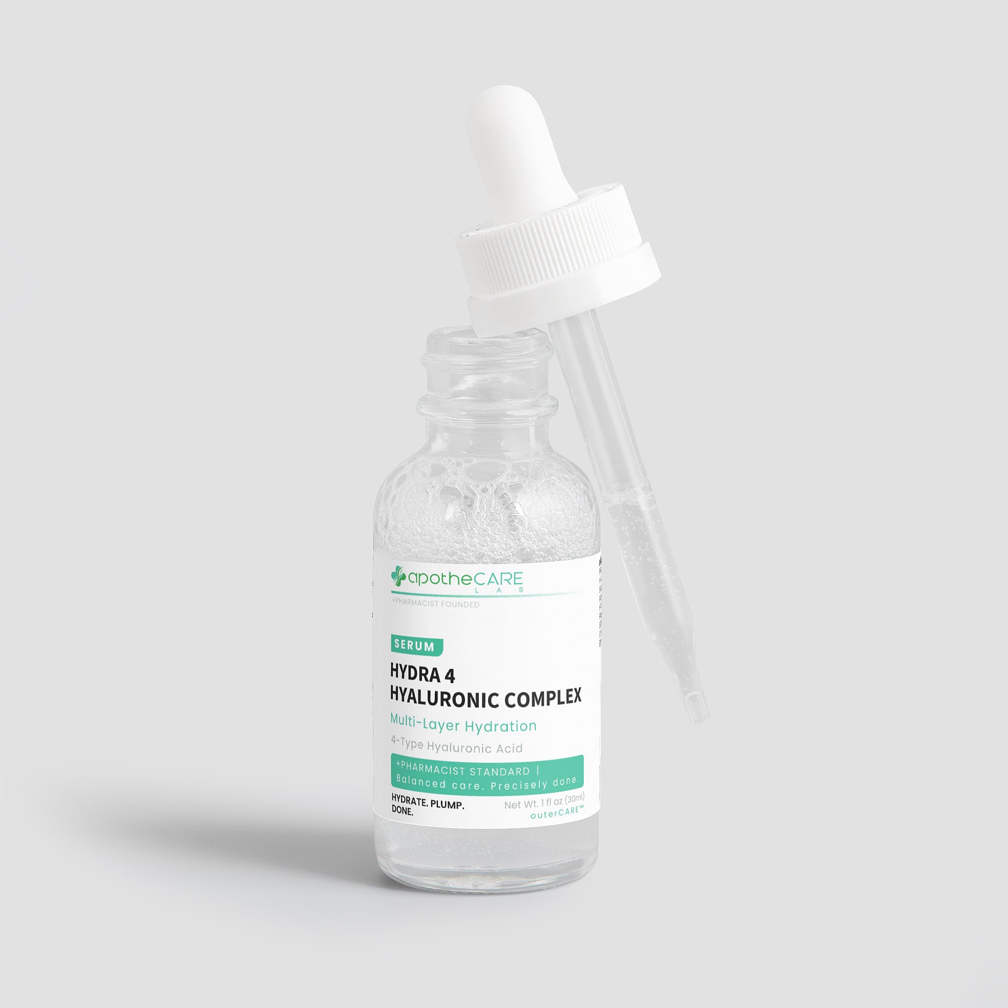 A clear glass dropper bottle of apotheCare Hydra 4 Hyaluronic Complex serum with a white dropper cap, set against a solid light gray background.
