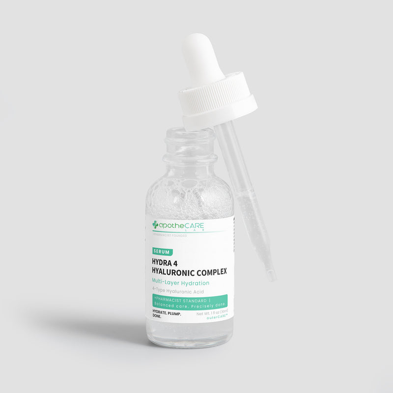A clear glass dropper bottle of apotheCare Hydra 4 Hyaluronic Complex serum with a white dropper cap, set against a solid light gray background.