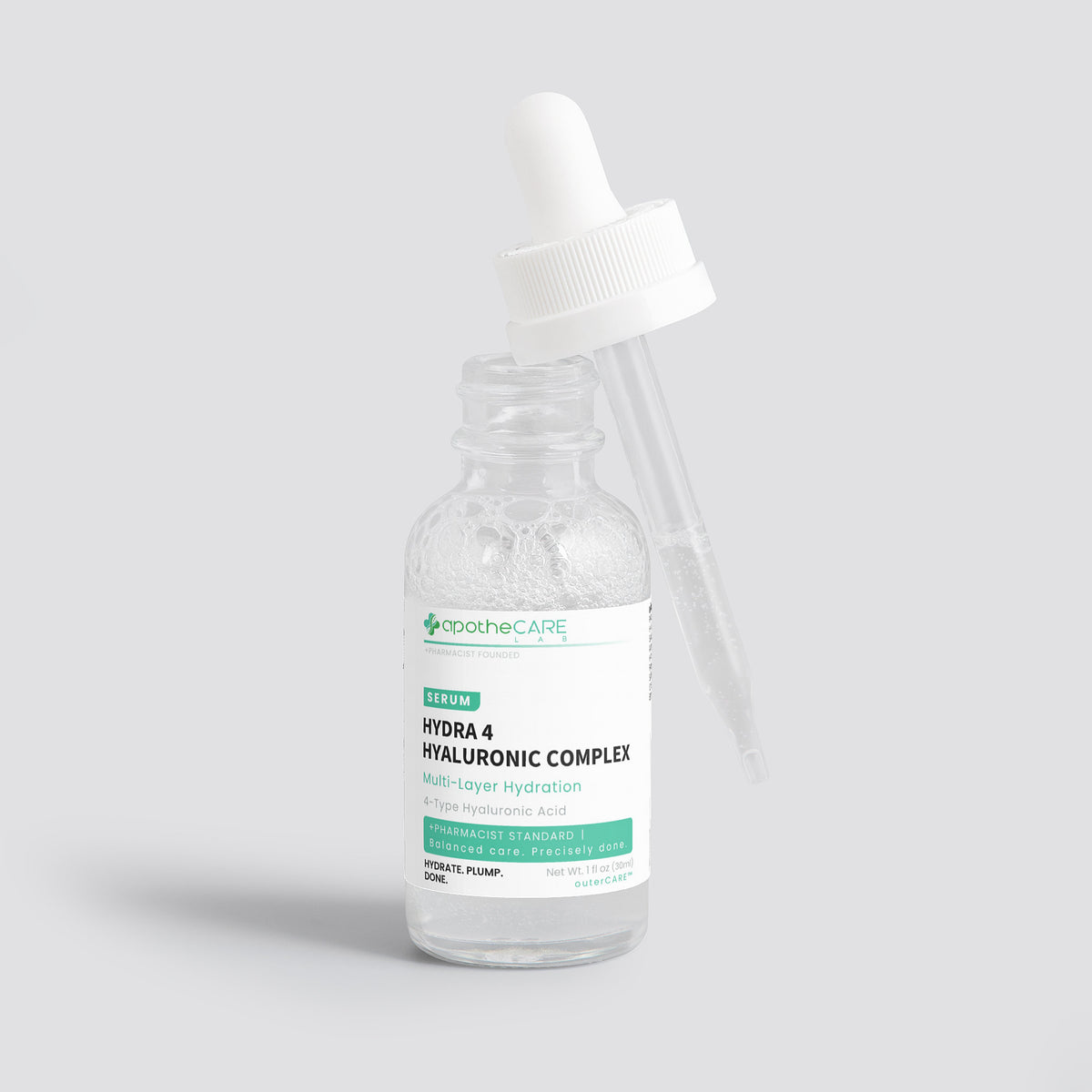 A clear glass dropper bottle of apotheCare Hydra 4 Hyaluronic Complex serum with a white dropper cap, set against a solid light gray background.