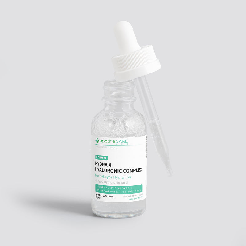 A clear glass dropper bottle of apotheCare Hydra 4 Hyaluronic Complex serum with a white dropper cap, set against a solid light gray background.