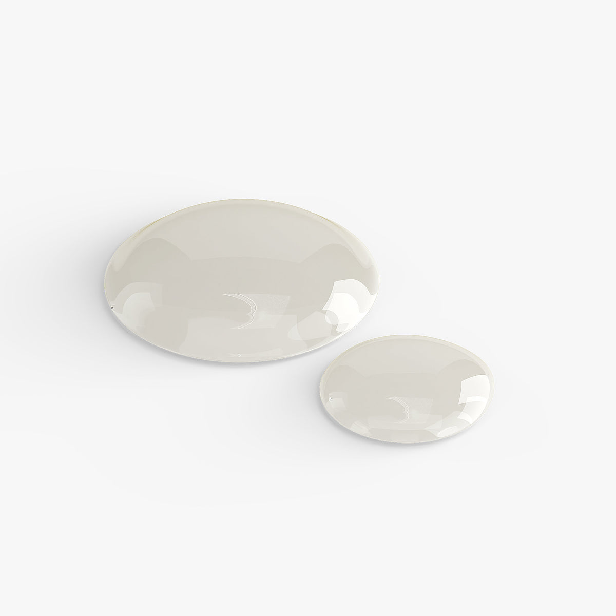 Two clear drops of liquid on a white background