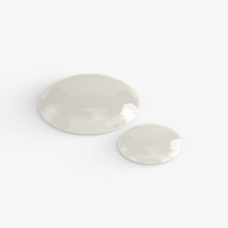Two clear drops of liquid on a white background