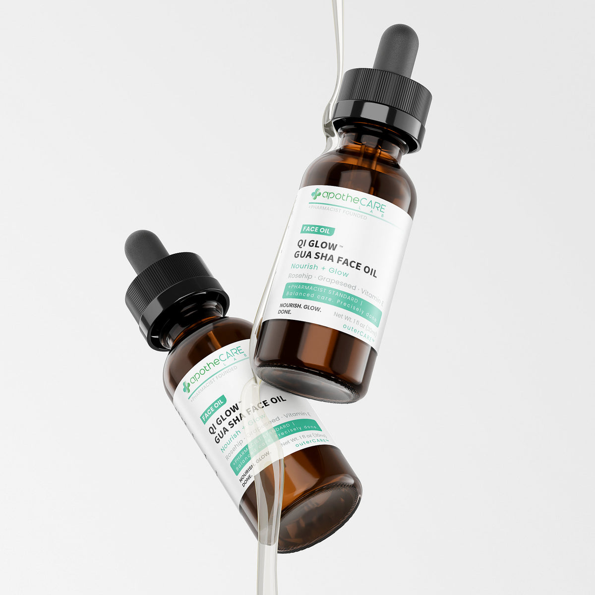 Two amber glass dropper bottles of Apothecare Lab QI Glow Gua Sha Face Oil floating against a clean light gray background.