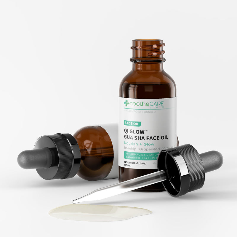 Brown glass bottle with dropper labeled Qi Glow on a white background