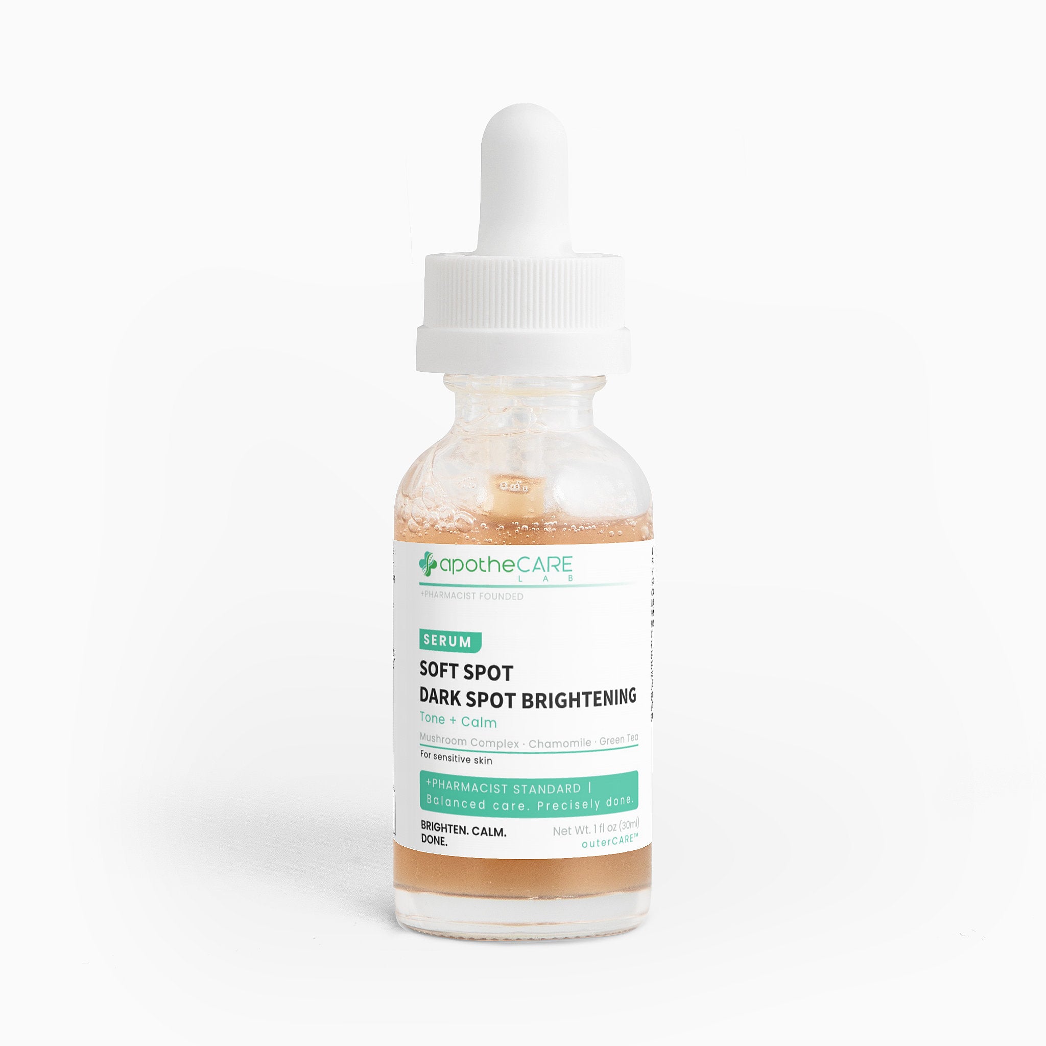 A clear glass dropper bottle of apotheCARE Soft Spot Dark Spot Brightening Serum with a white cap and white label, containing a light peach-colored liquid, set against a plain white background.