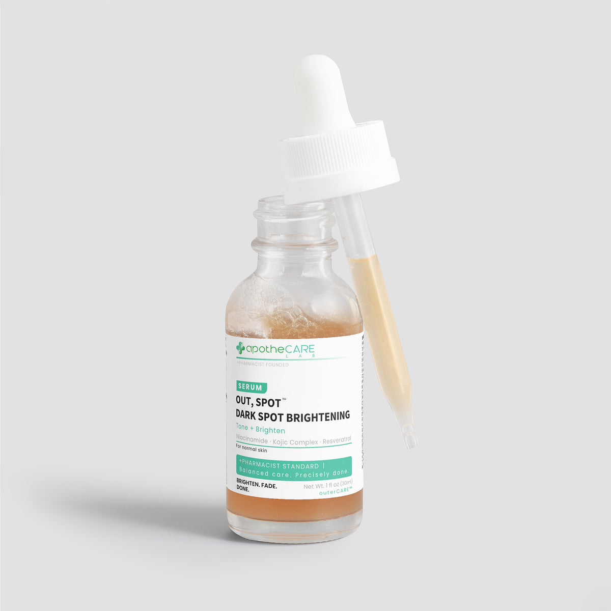 A clear glass dropper bottle of Apothecare Lab Out, Spot. Dark Spot Brightening serum with a white dropper cap, shown on a light gray background.