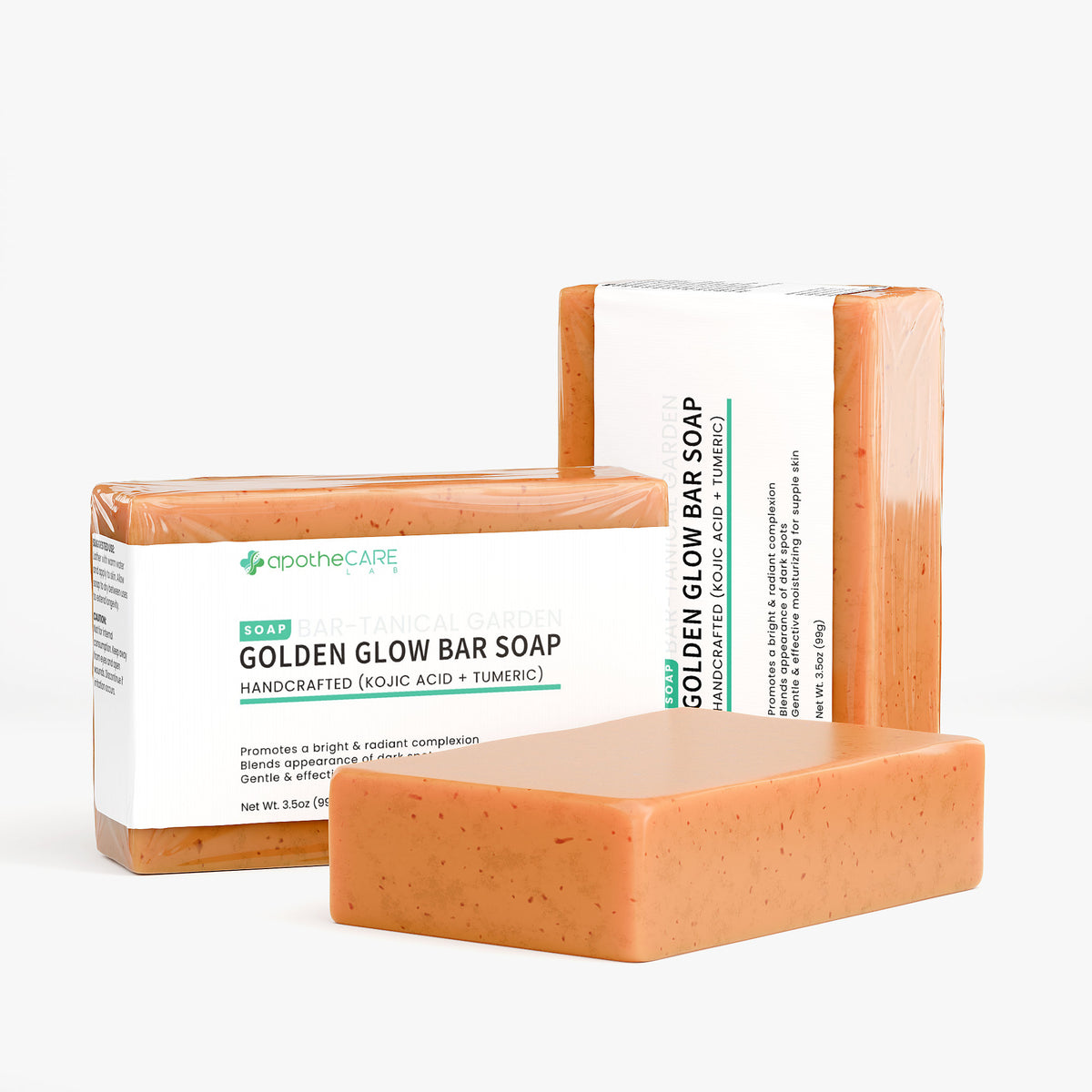 Three bars of Apothcare Golden Glow Bar Soap are displayed against a clean, off-white background. One bar is in the foreground, while two are wrapped in clear plastic with white labels behind it.