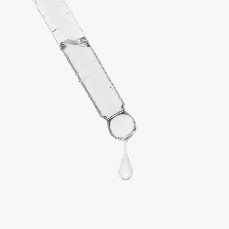 Dropper with clear liquid and a drop falling, on a white background