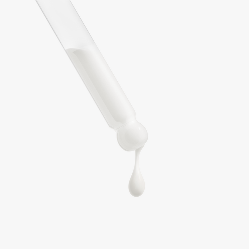White dropper with a drop of liquid on a light gray background