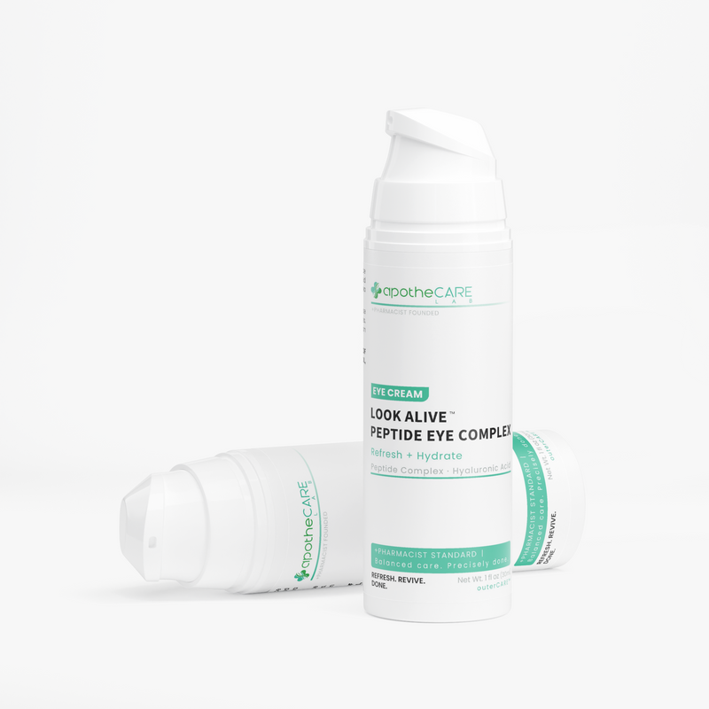 Two white bottles of ApotheCare Look Alive Peptide Eye Complex eye cream arranged on a clean white background, with one standing upright and two lying on their sides.